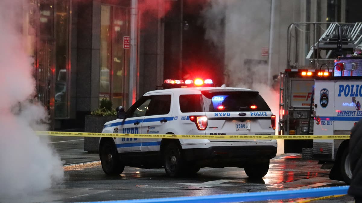 NYPD police vehicle on a rain-slicked New York City street at night