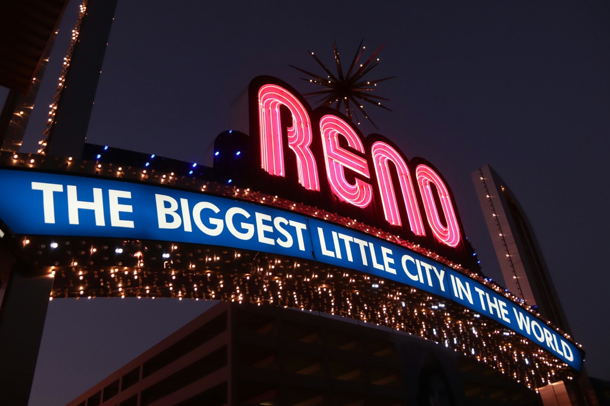 The Reno Arch at night with its pink neon Reno sign above the words The Biggest Little City in the World