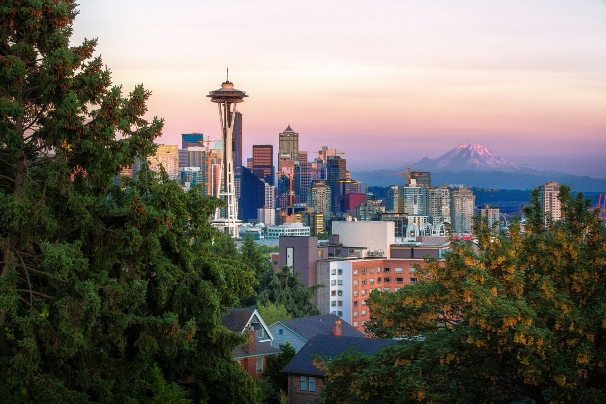Seattle skyline with the Space Needle and downtown towers, with Mount Rainier in the distance, at dusk