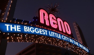 The Reno Arch at night with its pink neon Reno sign above the words The Biggest Little City in the World